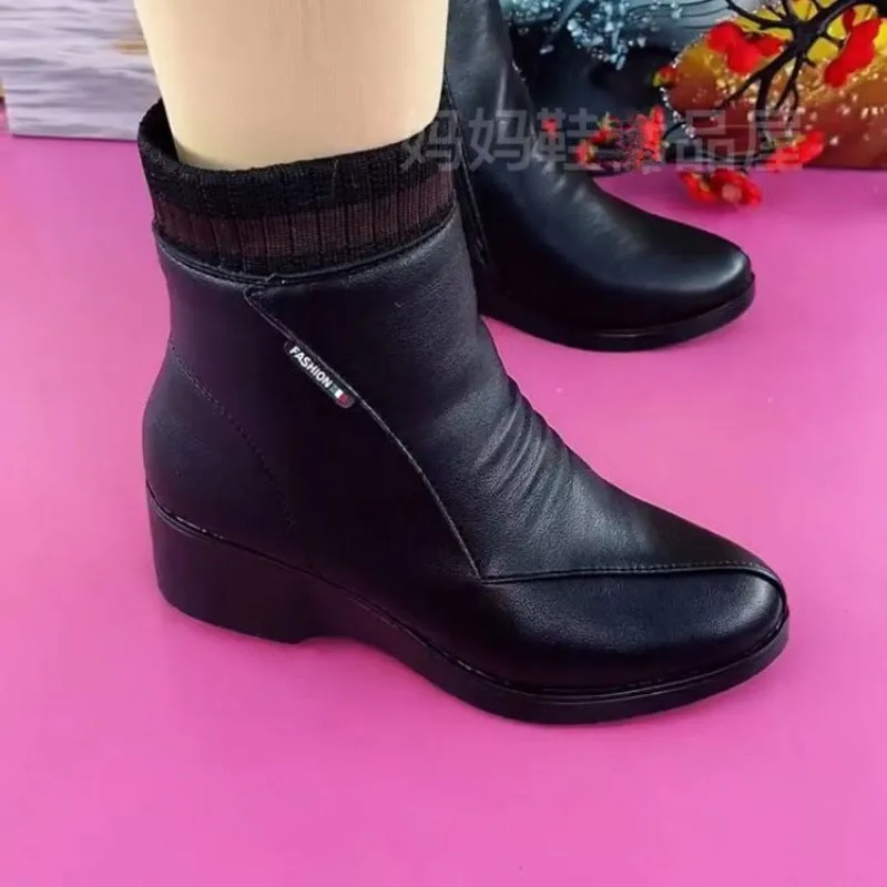 Women's soft leather ankle boots with mid heel, side zipper, and square heel in black