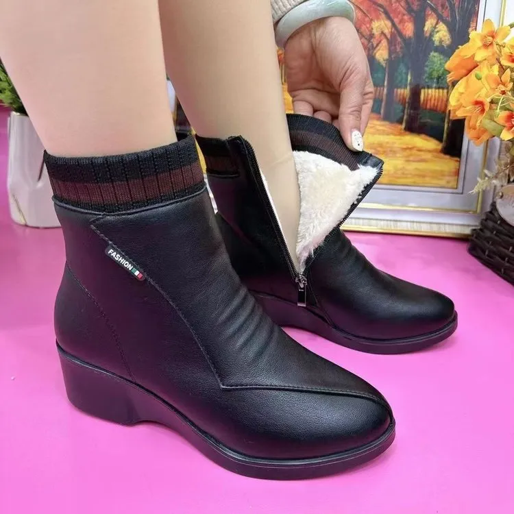 Women's soft leather ankle boots with mid heel, side zipper, and square heel in black