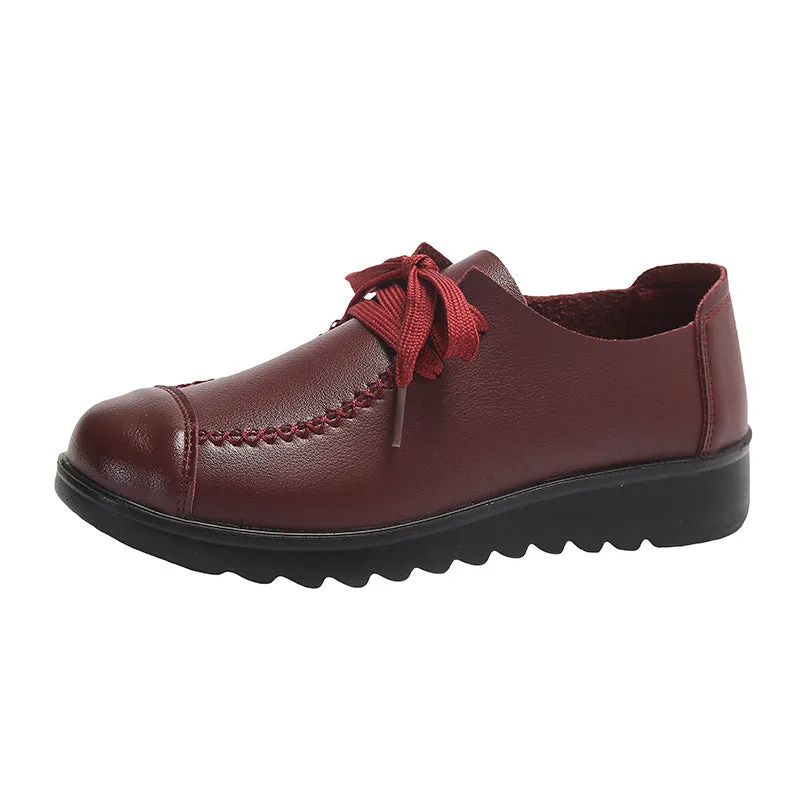 Women's black round toe flat work shoes with front lacing and soft anti-slip polyurethane sole