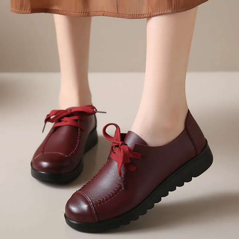 Women's black round toe flat work shoes with front lacing and soft anti-slip polyurethane sole