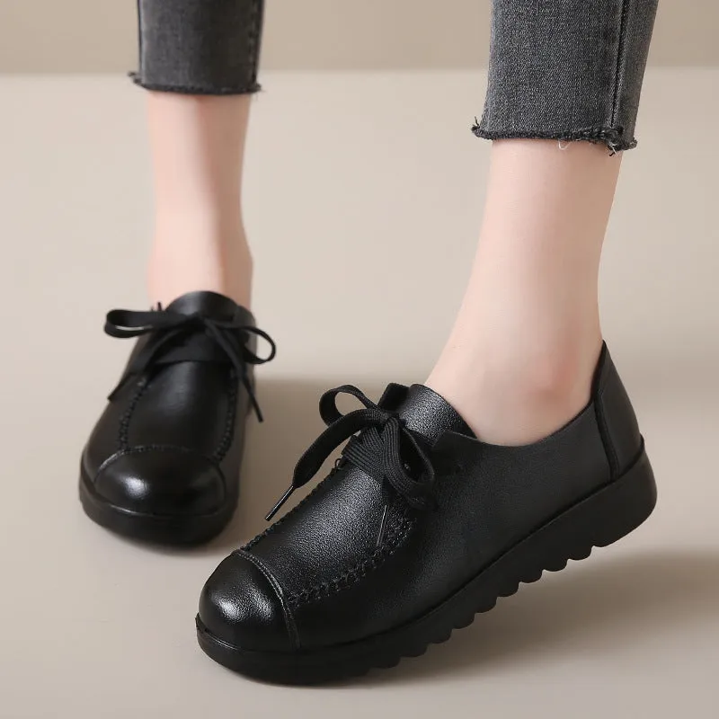 Women's black round toe flat work shoes with front lacing and soft anti-slip polyurethane sole