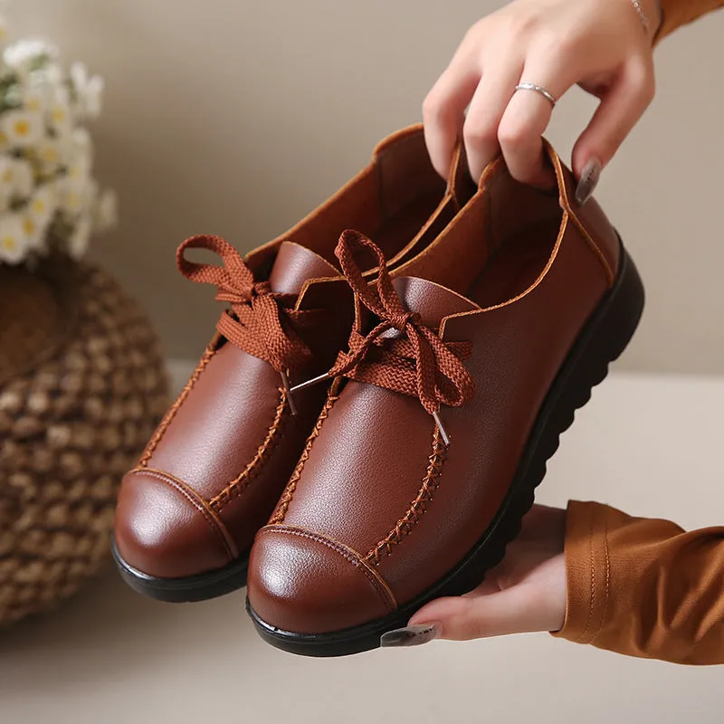 Women's black round toe flat work shoes with front lacing and soft anti-slip polyurethane sole