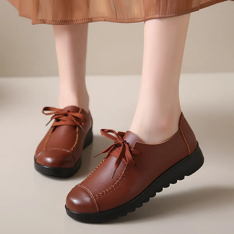 Women's black round toe flat work shoes with front lacing and soft anti-slip polyurethane sole