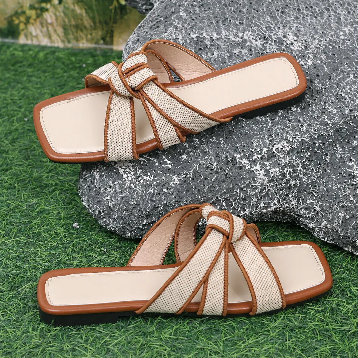 Women's half slippers with artificial PU upper and non-slip rubber sole in black and milky white on a light background