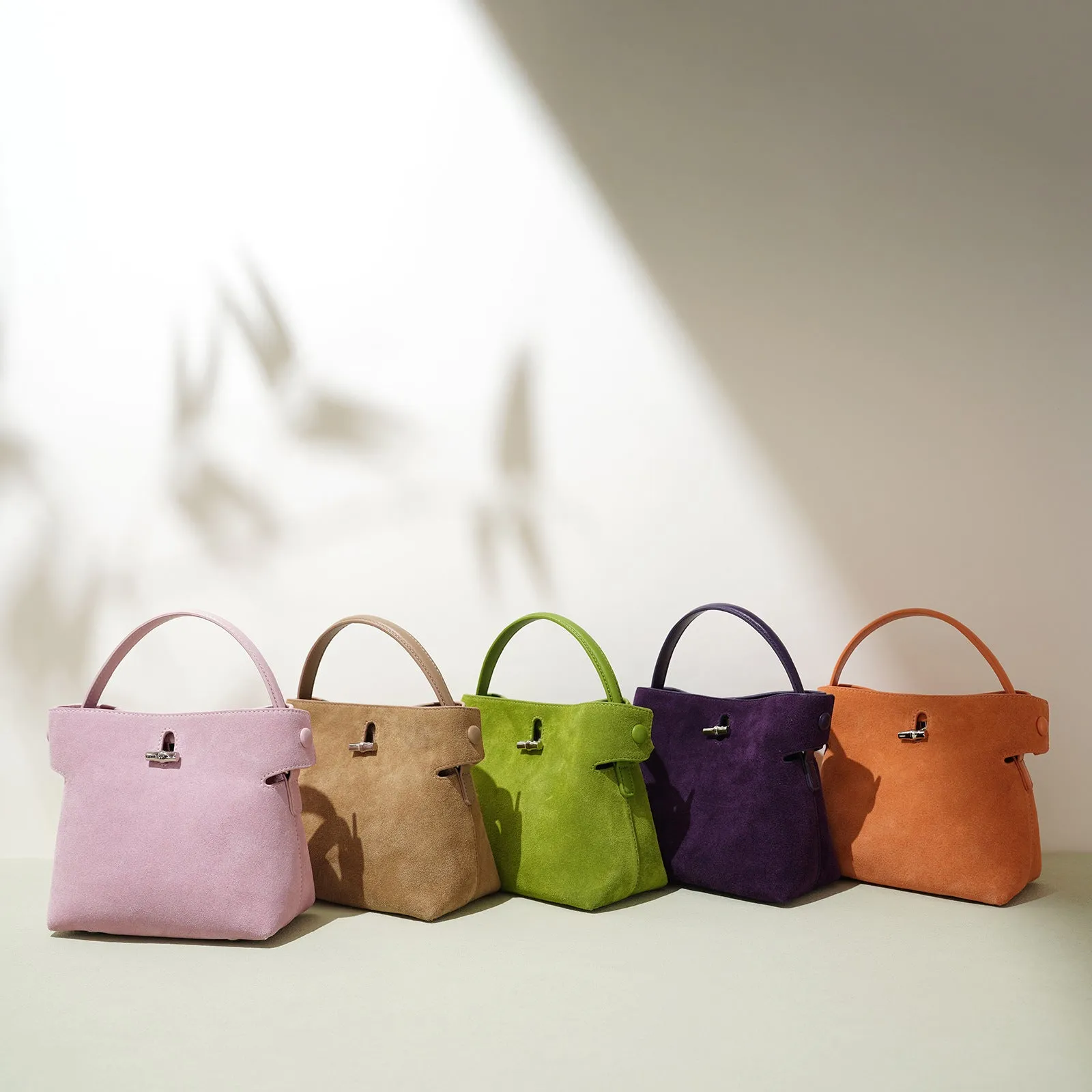 Women's mini Korean-style simple messenger bag in two-layer matte cowhide, bucket shape with lock opening, internal compartments