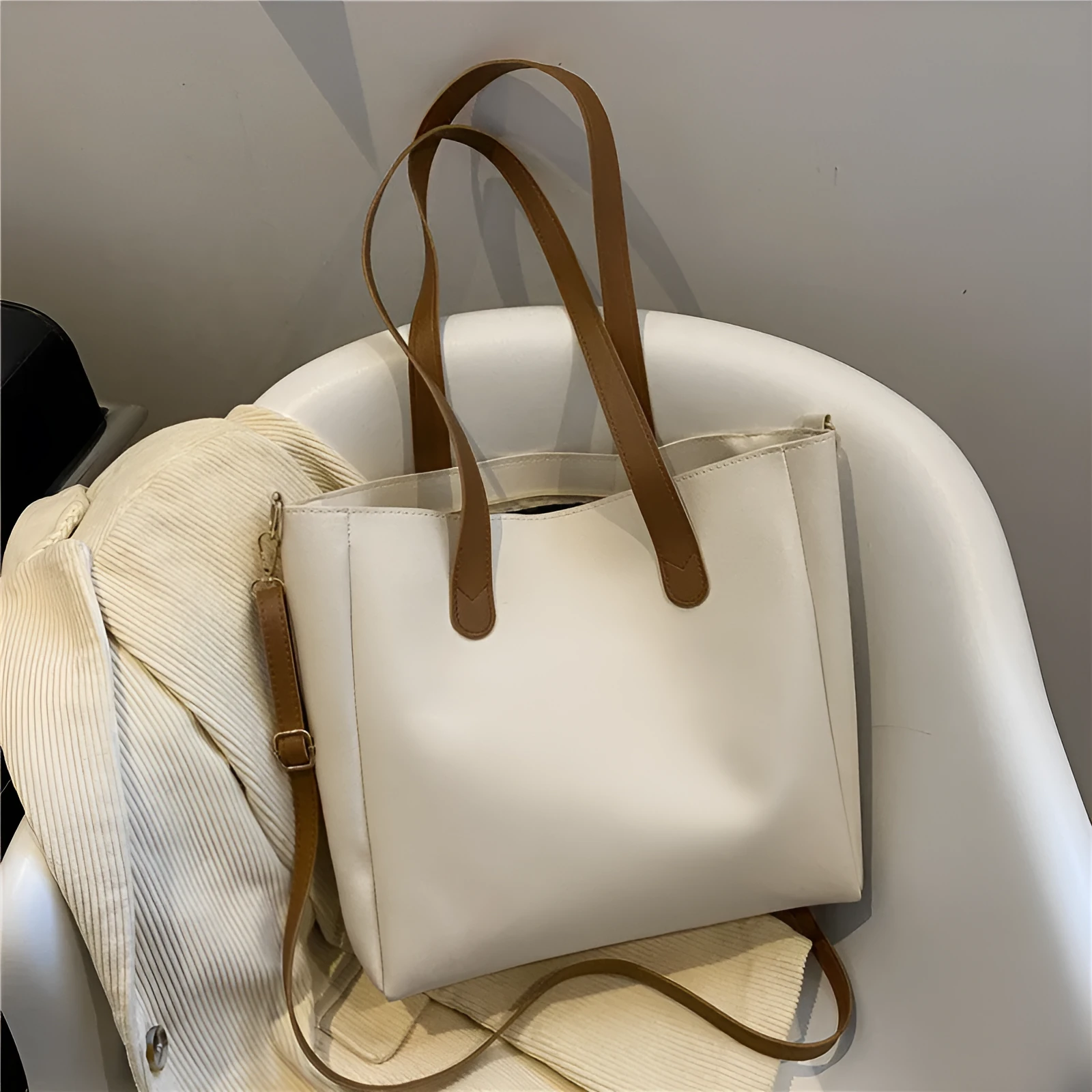 Single shoulder crossbody bag in horizontal square shape with PU exterior, available in black, brown, white, and yellow colourways