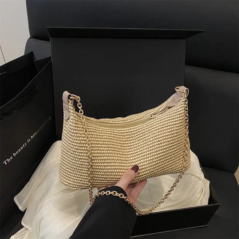 Khaki straw woven horizontal square tote bag with shoulder straps and outer sandwich pocket.