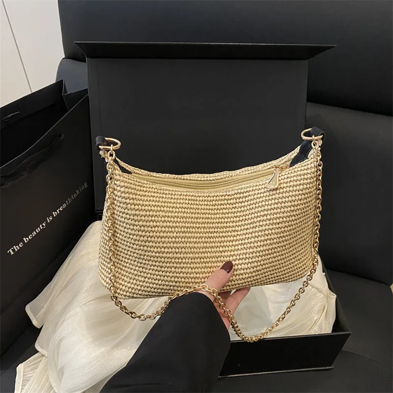 Khaki straw woven horizontal square tote bag with shoulder straps and outer sandwich pocket.