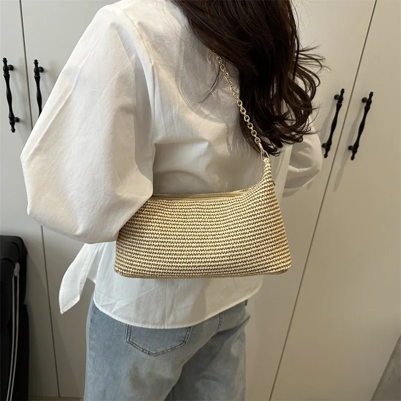 Khaki straw woven horizontal square tote bag with shoulder straps and outer sandwich pocket.