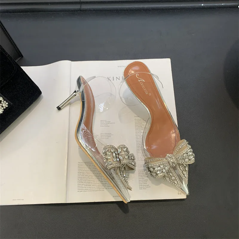 Silver women's bow rhinestone pointed transparent high heel sandals on display