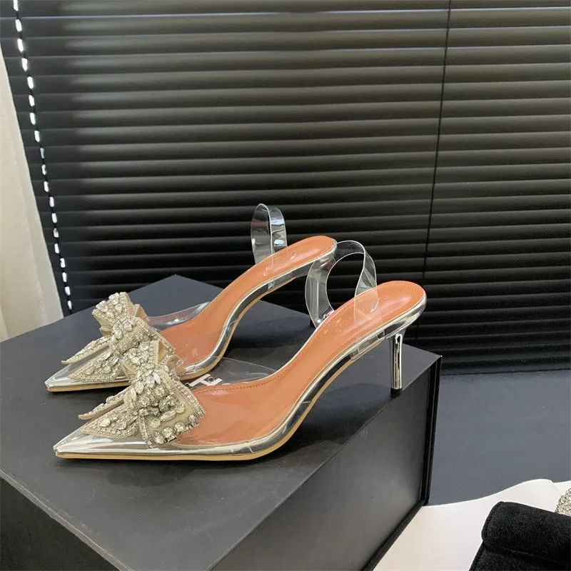 Silver women's bow rhinestone pointed transparent high heel sandals on display