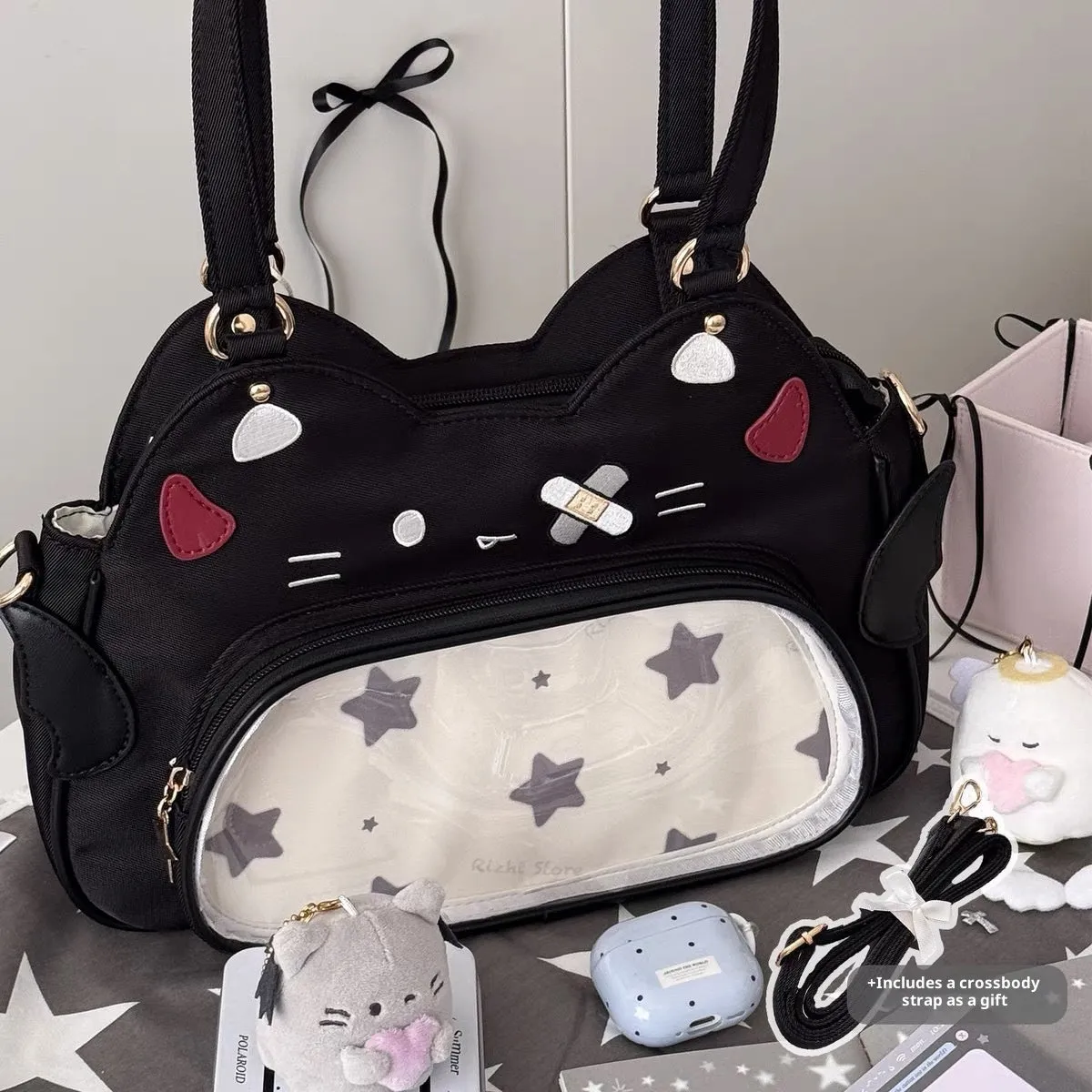 Horizontal cartoon owl pin PU crossbody bag in black, side view showing stitching and single strap