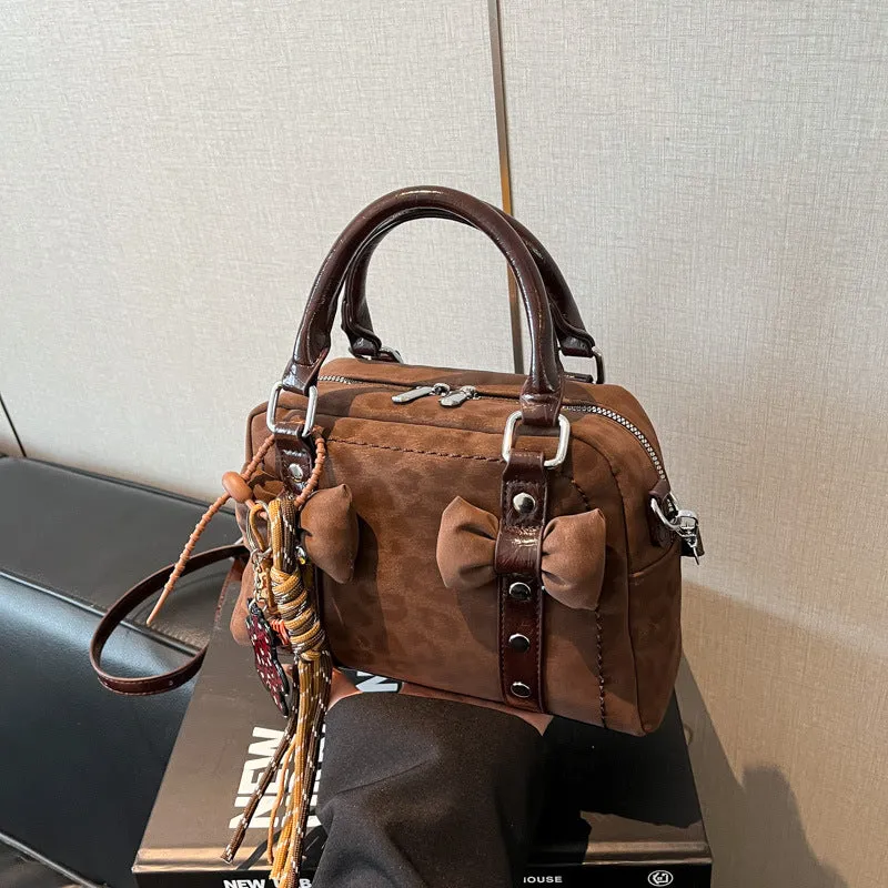 Soft PU pillow bag with crossbody strap, stitching, rivets, and leopard print in brown with pendant