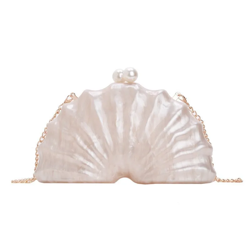 Acrylic shell-shaped clutch bag in champagne with silver chain on white background