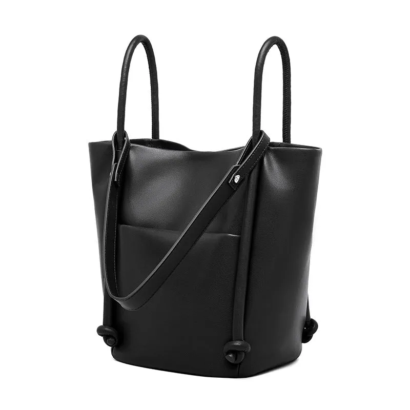Soft cowhide genuine leather bucket tote bag in black with crossbody strap, 26cm height, urban minimalist design