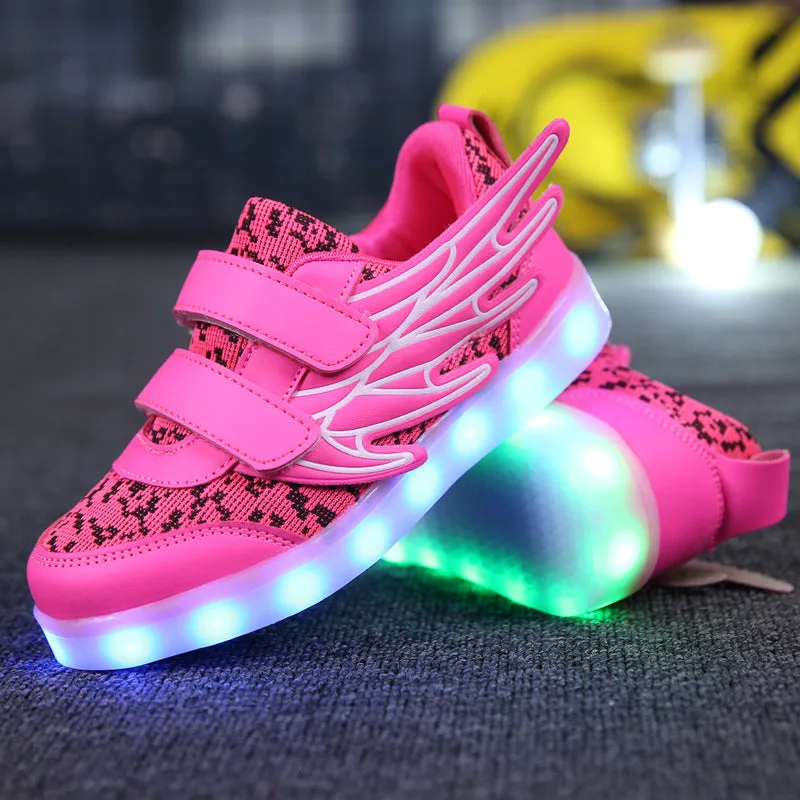 Children's plum red and white LED light-up sneakers showing USB charging port and colourful illumination.