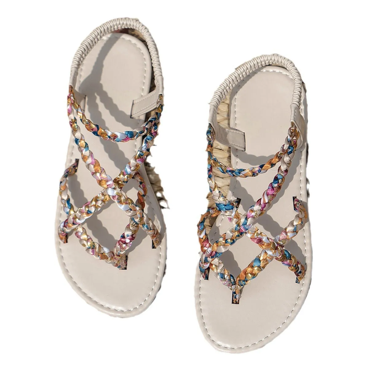 Adult flat sandals with elastic band, round toe, and cloth upper in black and white colours.