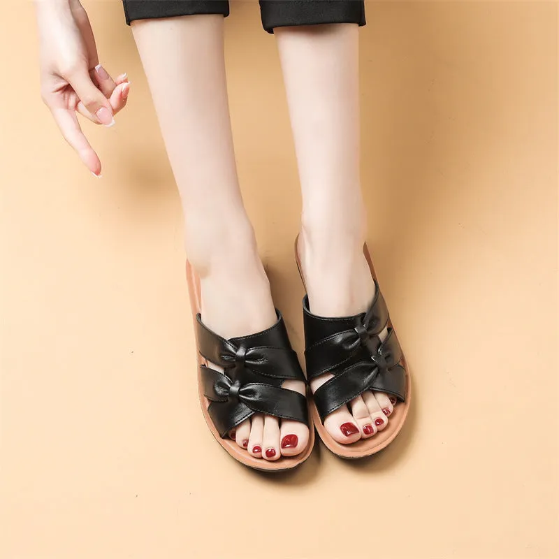 Beige cowhide leather slippers with a soft sole, shown from the side.