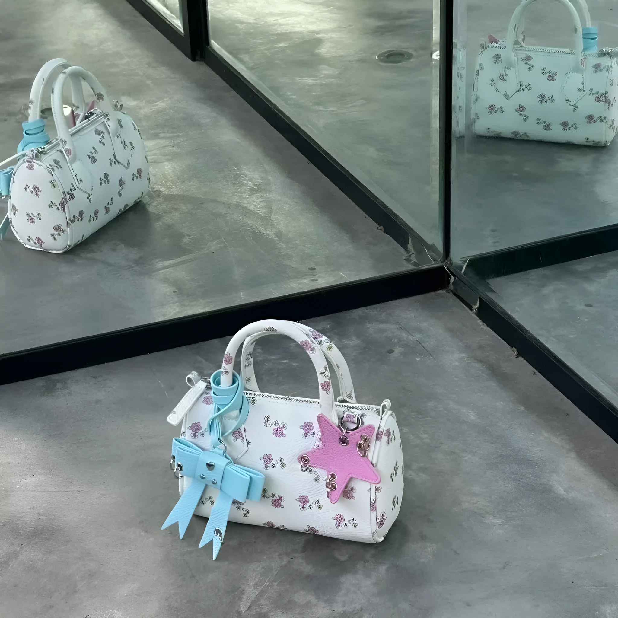 White PU hand-held shoulder bag with petite floral bow accessory on display