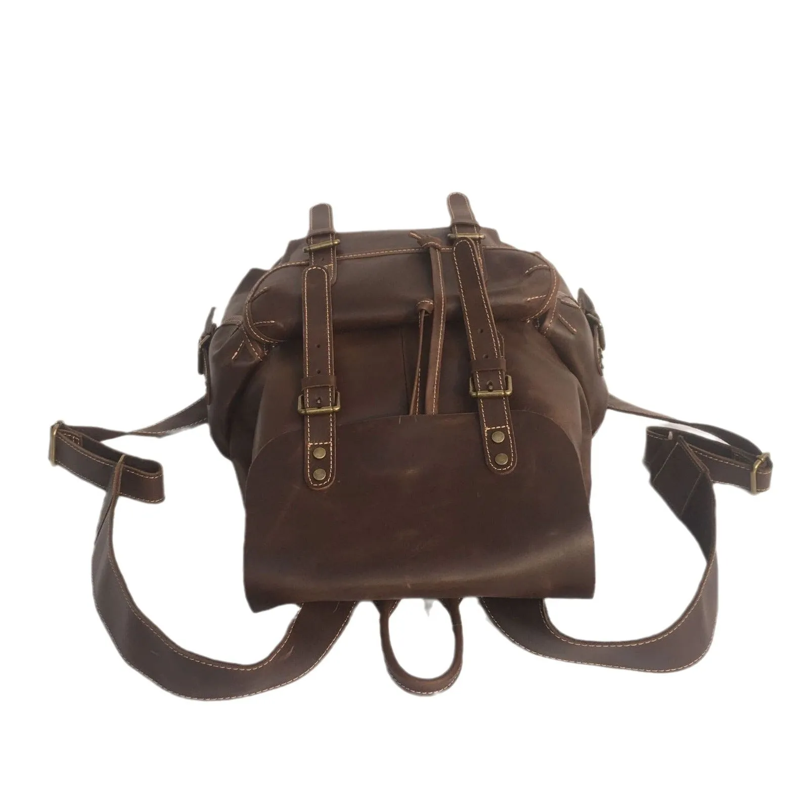 Brown men's leather backpack showing genuine cowhide material and integrated air pillow shoulder straps.