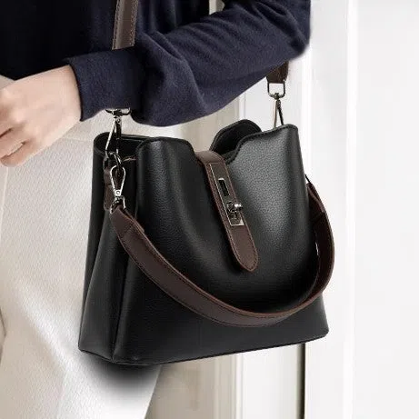 Textured PU bucket bag in black with patchwork stitching, horizontal rectangular shape, single shoulder strap.