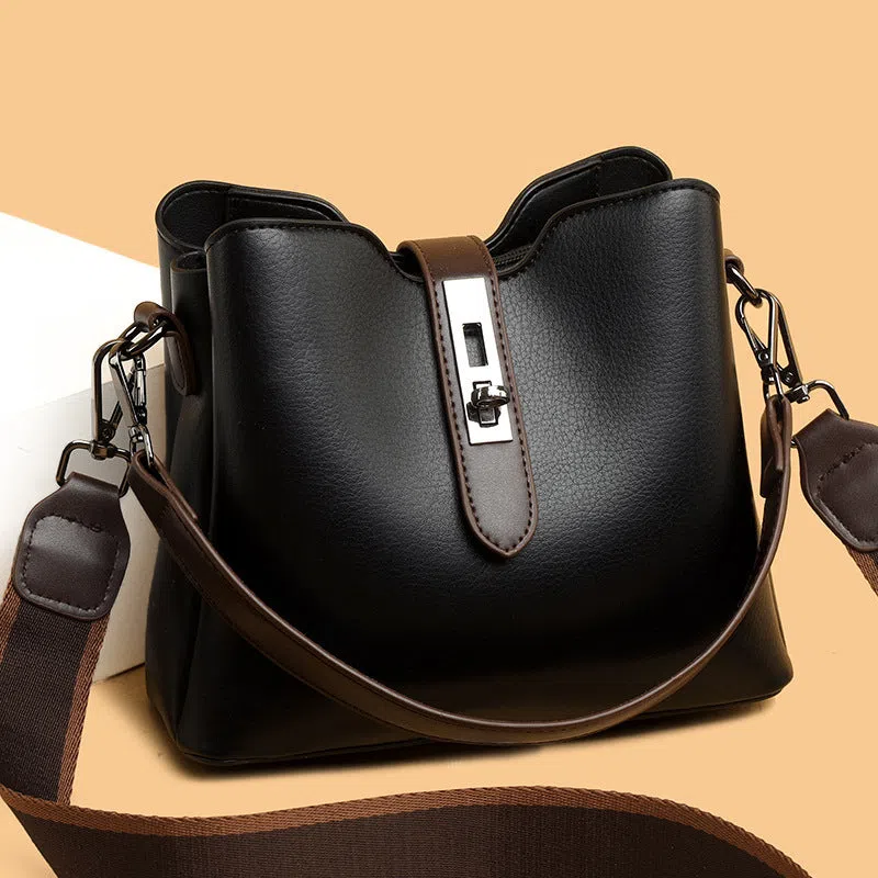 Textured PU bucket bag in black with patchwork stitching, horizontal rectangular shape, single shoulder strap.