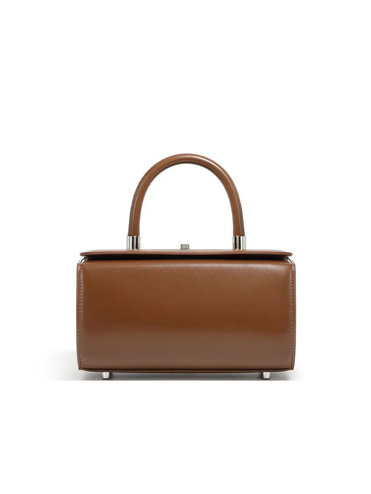 Brown leather women's crossbody bag with a box shape and clamshell opening, shown with interior phone and file pockets.