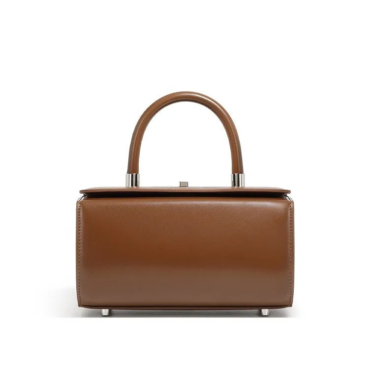 Brown leather women's crossbody bag with a box shape and clamshell opening, shown with interior phone and file pockets.