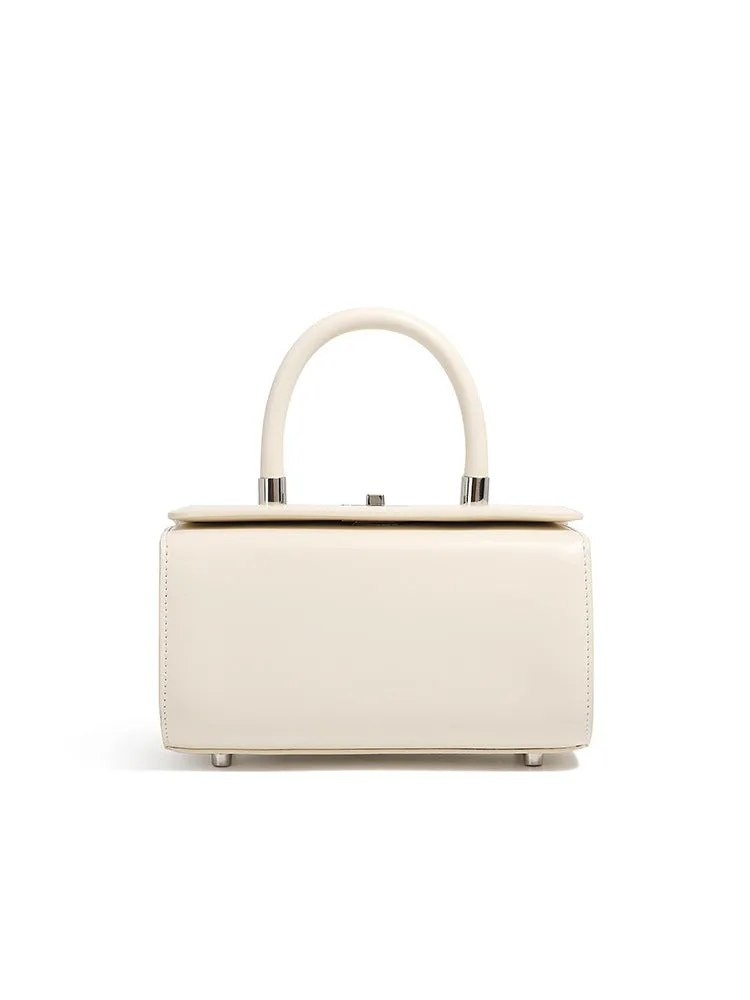 Brown leather women's crossbody bag with a box shape and clamshell opening, shown with interior phone and file pockets.