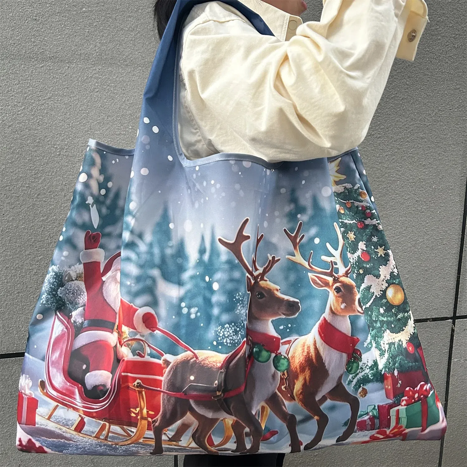 Large one-shoulder polyester Santa Claus gift bag with festive red and white design