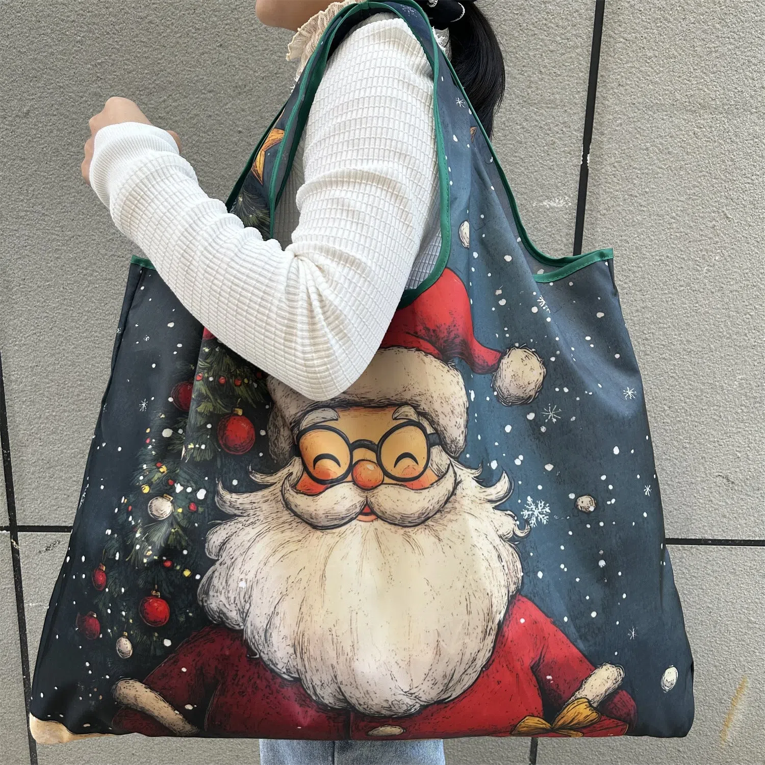 Large one-shoulder polyester Santa Claus gift bag with festive red and white design
