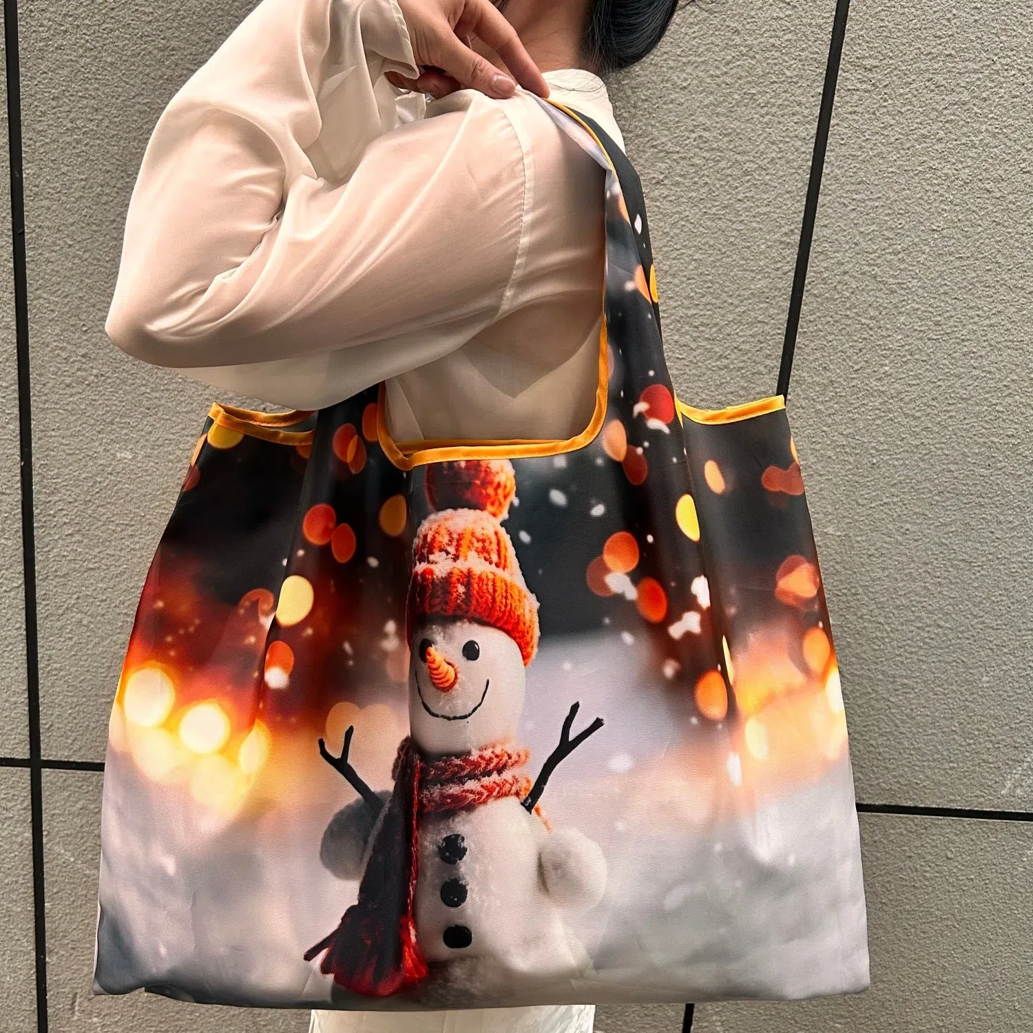 Large one-shoulder polyester Santa Claus gift bag with festive red and white design