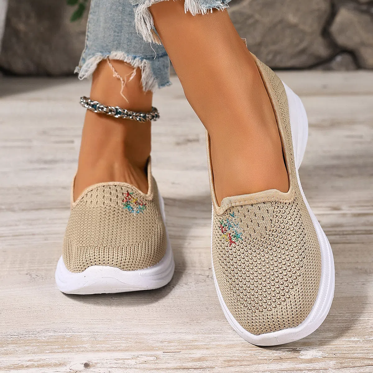 Women's mesh casual slip-on shoes in beige with round toe and low-cut shaft on a plain background