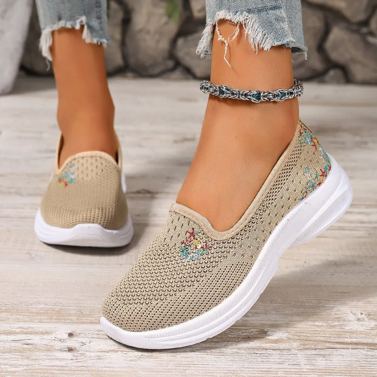 Women's mesh casual slip-on shoes in beige with round toe and low-cut shaft on a plain background