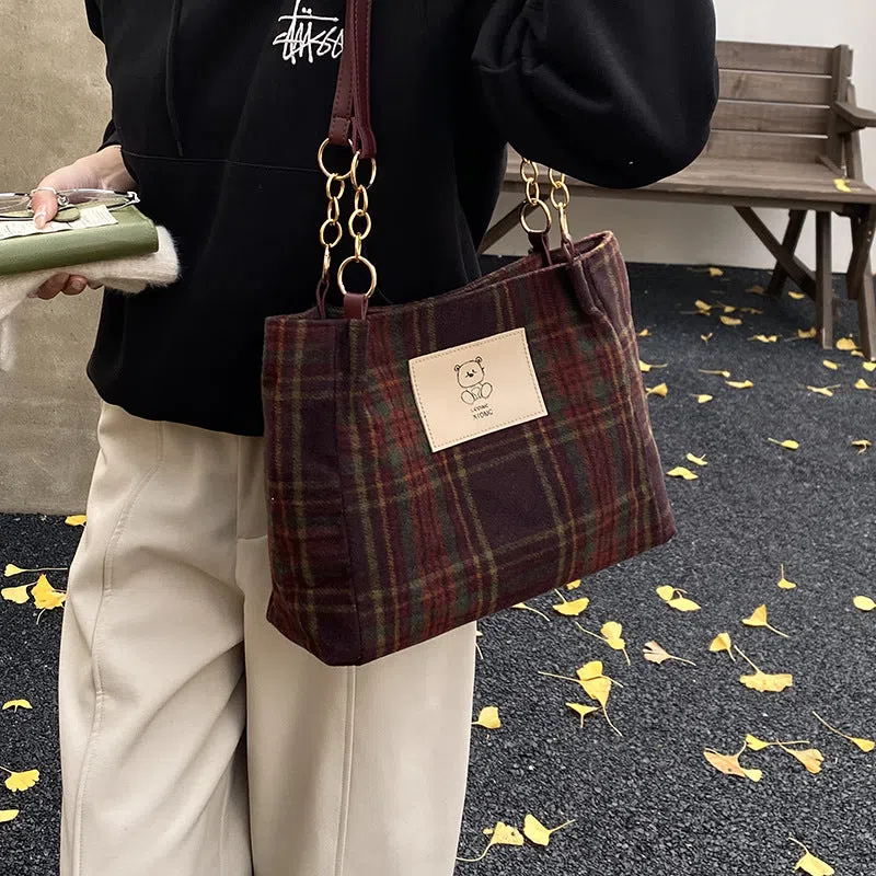 Wool plaid women's single-shoulder commuter bag in brown with stitched seam detailing and double straps