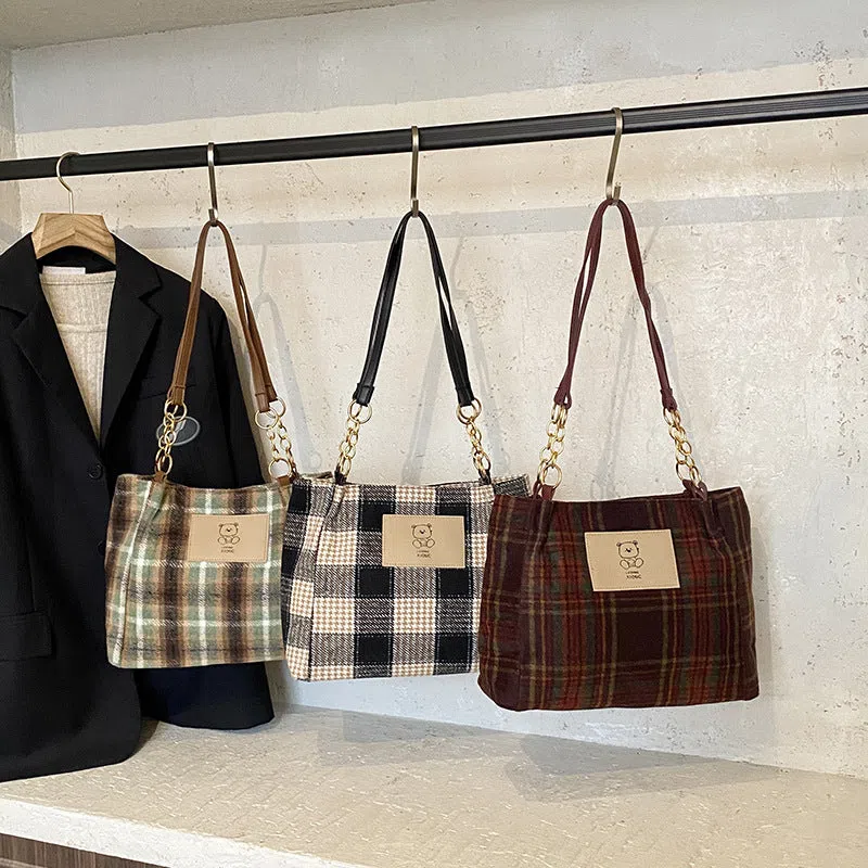 Wool plaid women's single-shoulder commuter bag in brown with stitched seam detailing and double straps