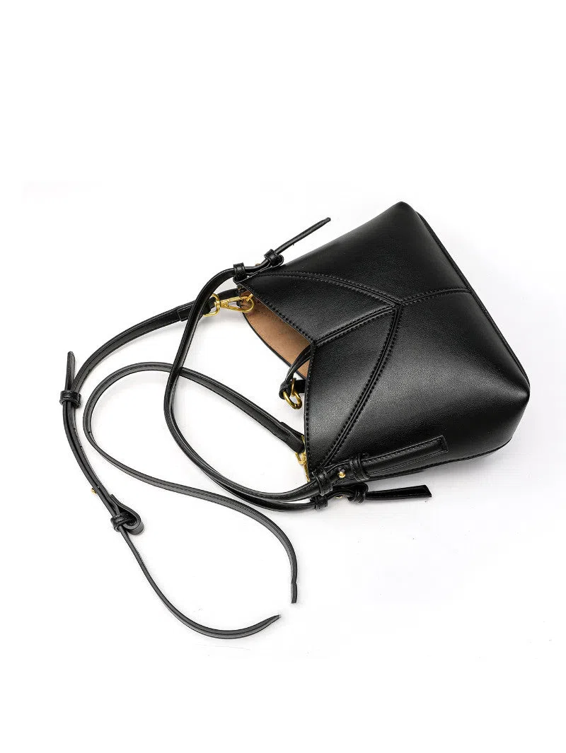 Trendy solid colour stitched oval handbag and crossbody bag for women in black with single shoulder strap and interior slip pocket