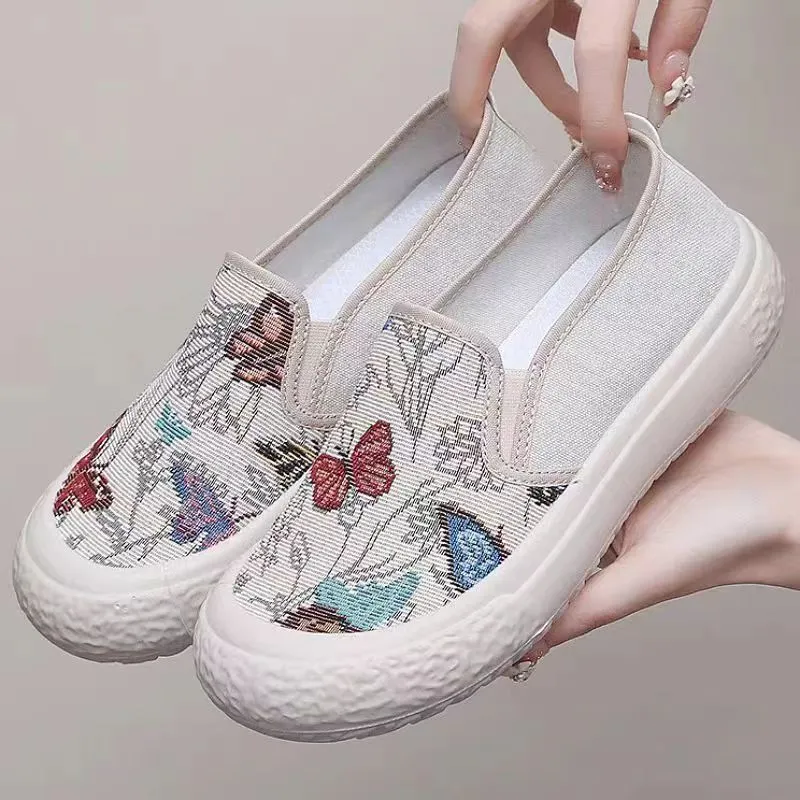Women's slip-on canvas shoes in Black with round toe and decorative sewing thread details