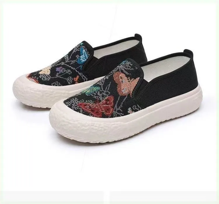 Women's slip-on canvas shoes in Black with round toe and decorative sewing thread details
