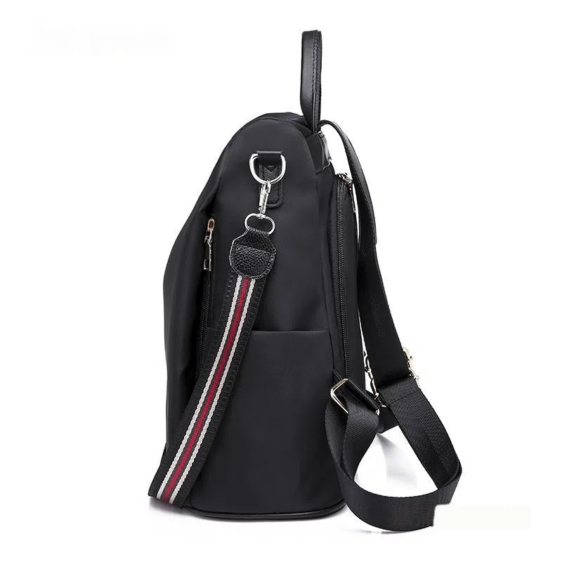 Women's large capacity black backpack with Oxford fabric lining, laptop sleeve, and trendy stitched seams and colour blocking