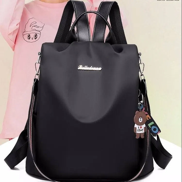 Women's large capacity black backpack with Oxford fabric lining, laptop sleeve, and trendy stitched seams and colour blocking