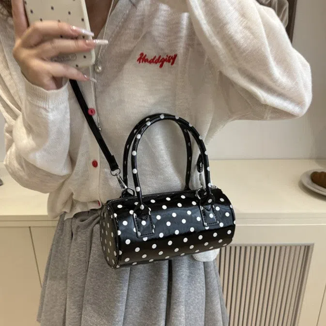 Korean-style cylindrical tote pillow bag in PU leather with stitched seams, black colour, single strap
