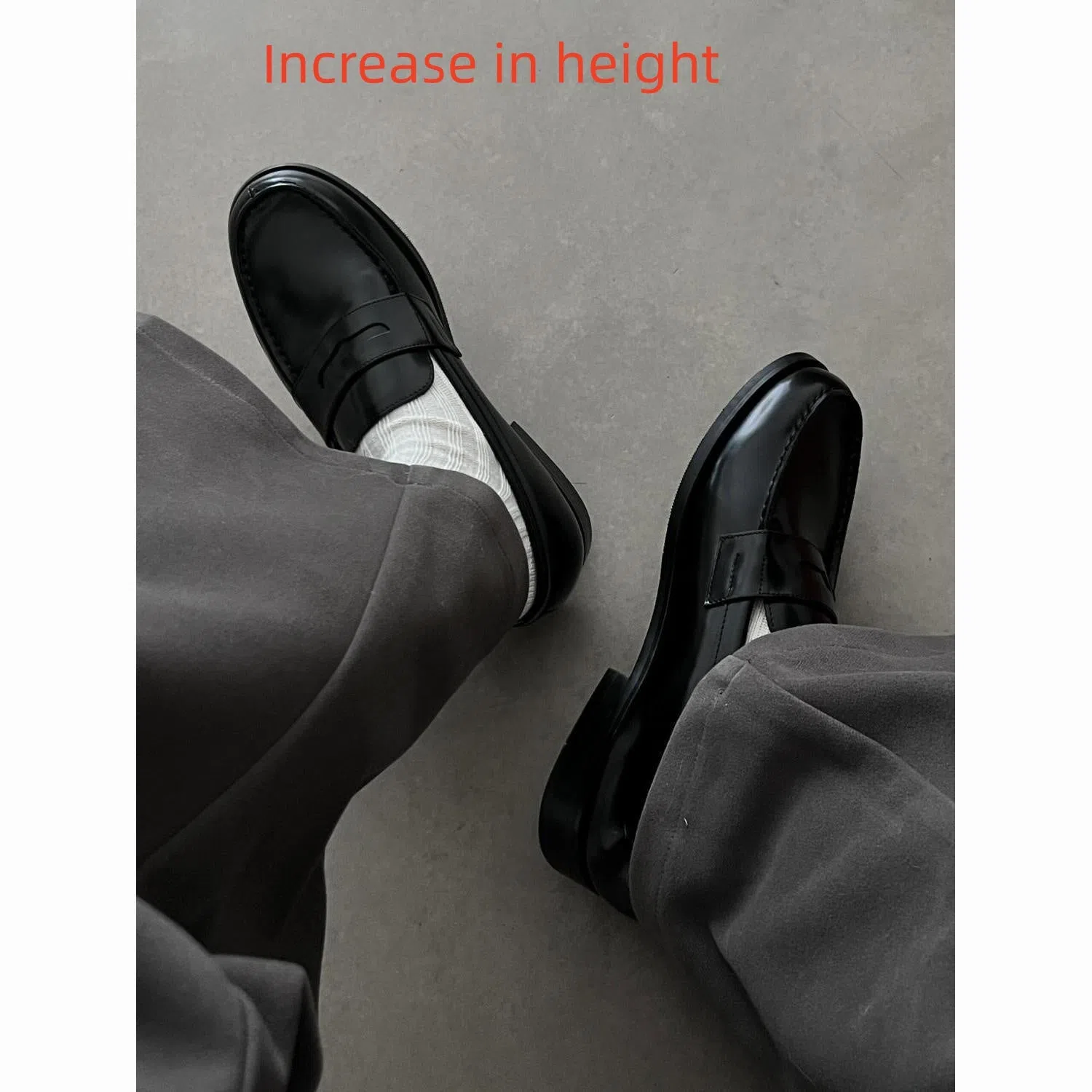 Men's black leather loafers with stitched seams, square heel, and vulcanised rubber sole on display