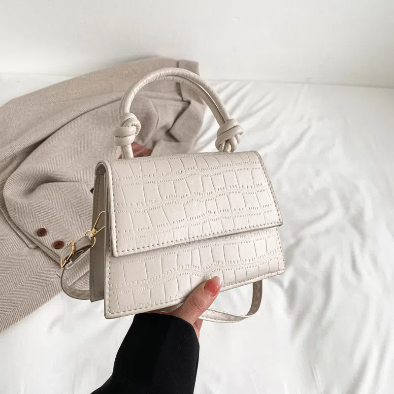 Women's soft PU underarm bag in horizontal rectangle shape with stitched seams and single shoulder strap