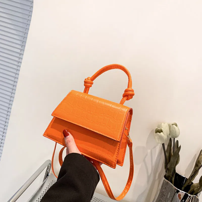 Women's soft PU underarm bag in horizontal rectangle shape with stitched seams and single shoulder strap