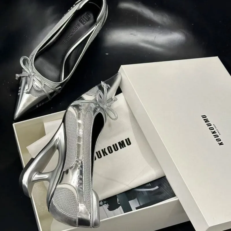 Women's black pointed toe Mary Jane shoes with a distinctive shaped floating heel and slip-on design.