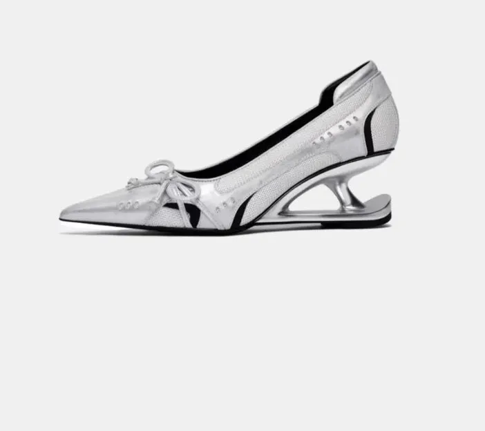 Women's black pointed toe Mary Jane shoes with a distinctive shaped floating heel and slip-on design.