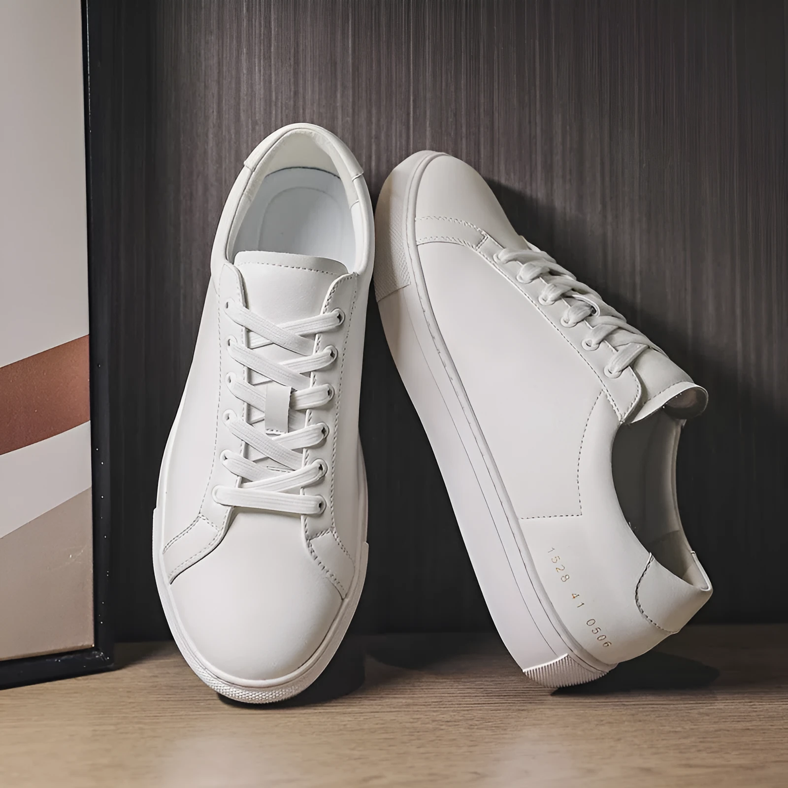 White flat-soled cowhide sneakers with stitching detail and round toe