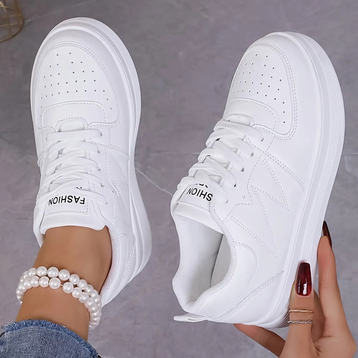 Children's low-top lace-up sneakers in white with canvas upper and thick sole, side view