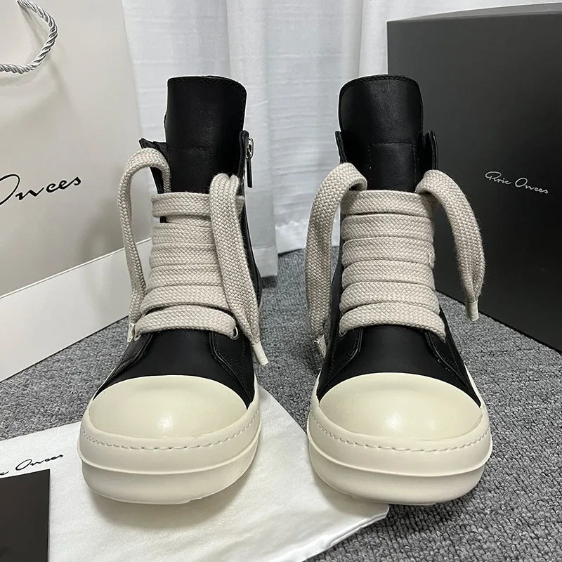 Black leather high-top sneakers with side zipper and round toe on a rubber platform sole
